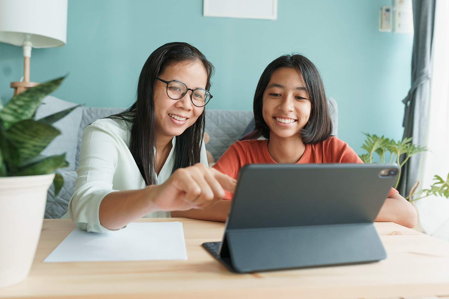 Mom and daughter logging into online therapy session together