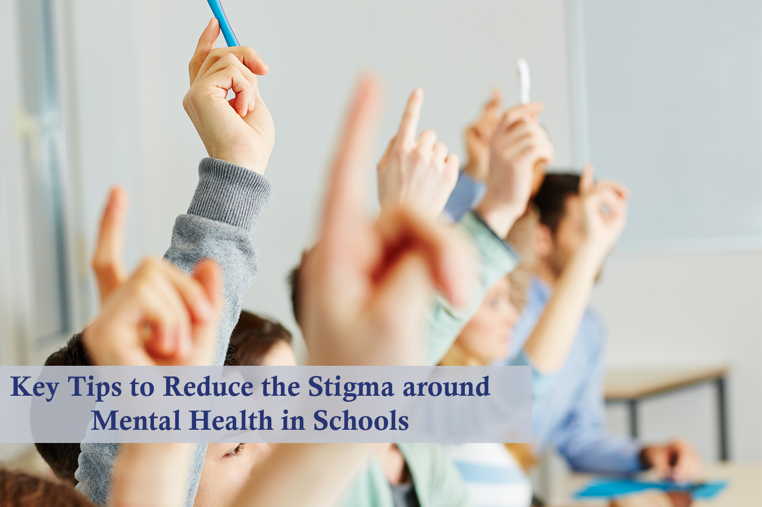 Anonymous students raising their hands in a classroom in an effort to fight the stigma around mental health.