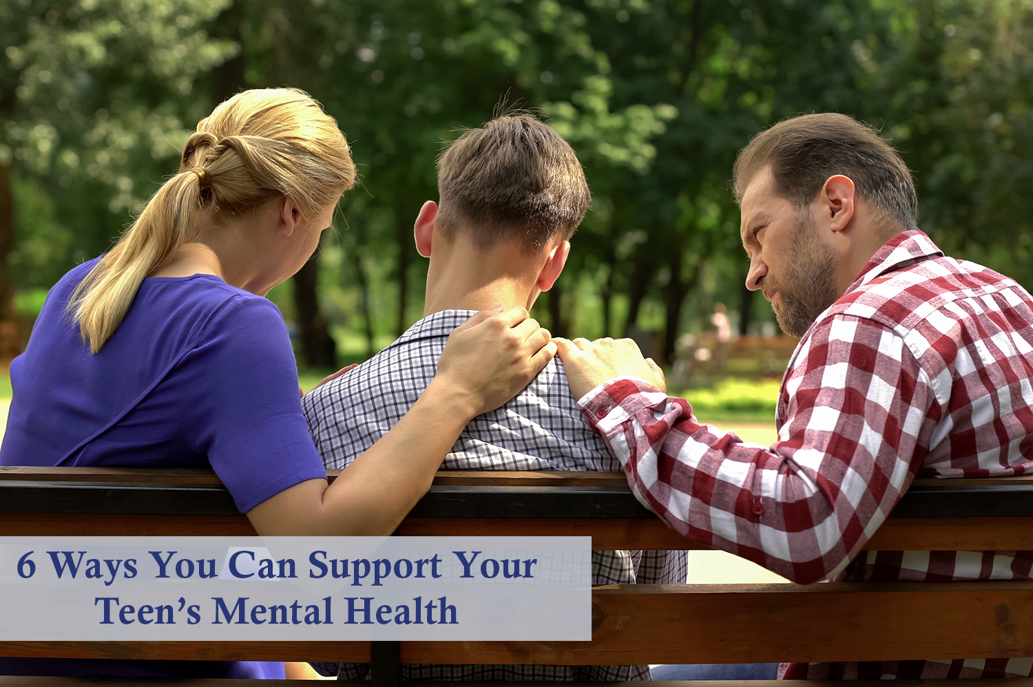Anonymous mother and father sitting on bench with teen son with backs faced to viewer. Their hands are on the son's shoulders to show support for their teen's mental health.