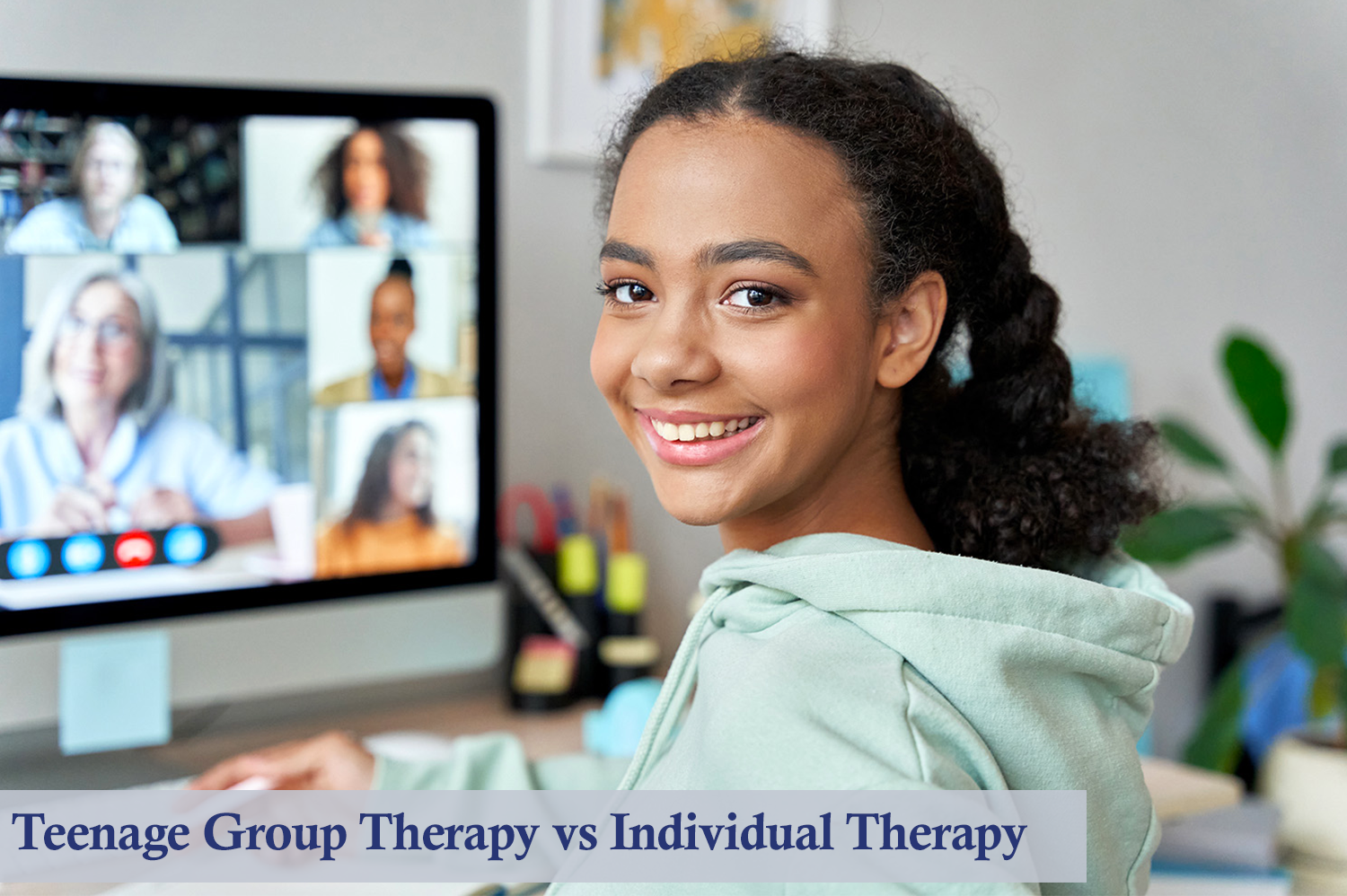 Tween girl sitting in front of computer attending teenage group therapy.